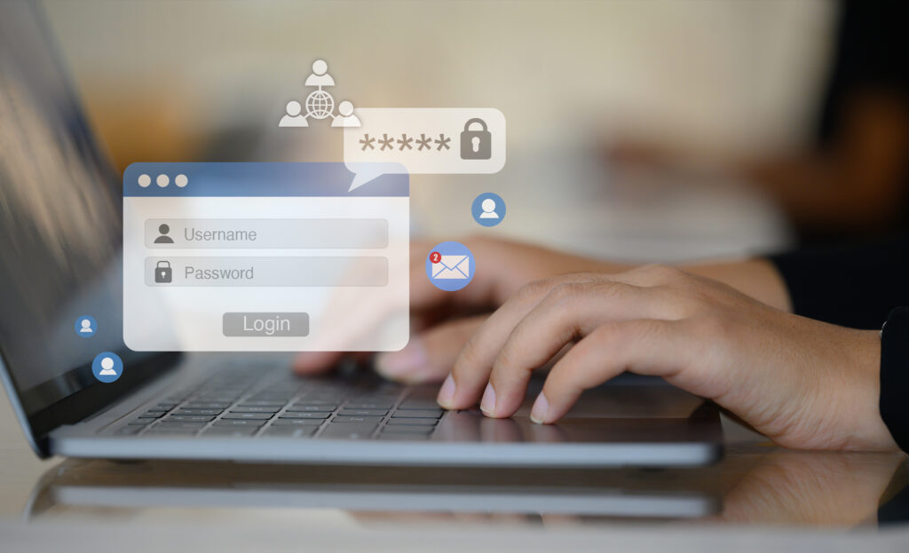 Woman hands typing username and password on her laptop to access account on website