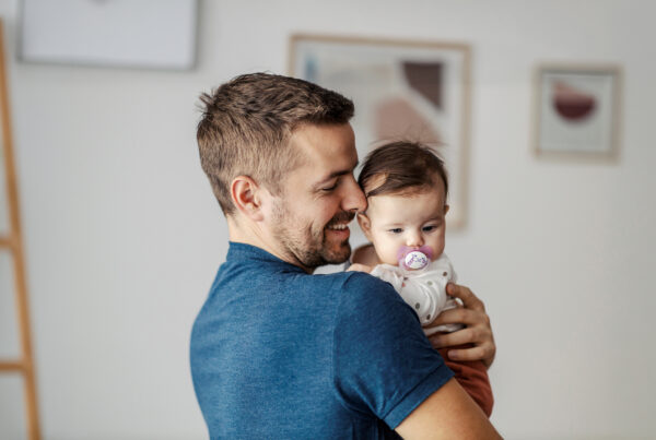 A happy father hugging his little daughter.