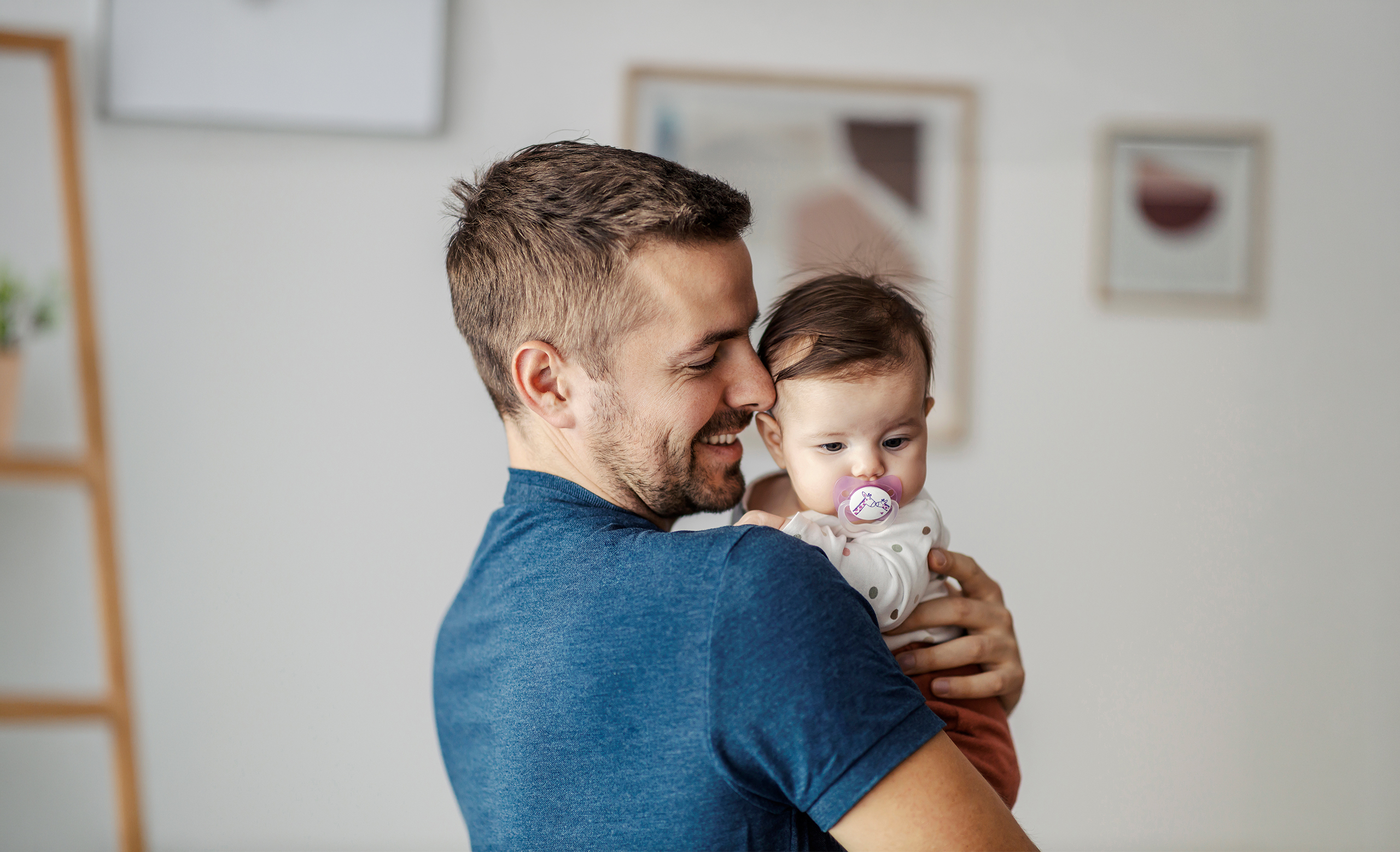 A happy father hugging his little daughter.